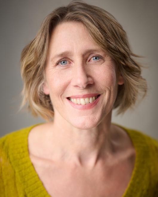 Portrait image of Tamsin Shasha smiling at the camera