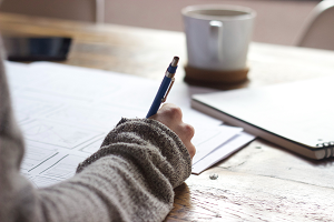 student writing at table