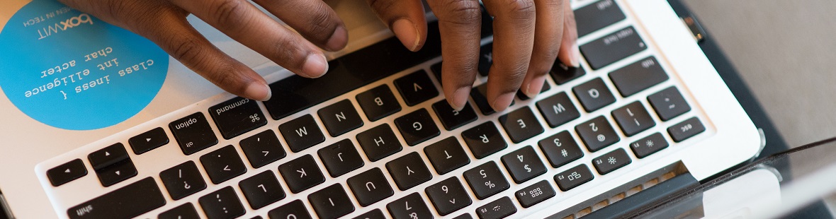 Hands typing on keyboard CREDIT WOC in Tech