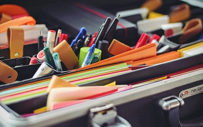 Colourful stationary sits in a box on a desk