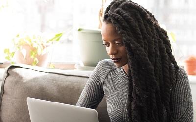 A professional uses a laptop to type