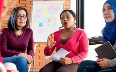 Images shows three women in a meeting