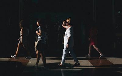 Image shows a group of women walking along a street. Photo credit: Simone Viani on Unsplash