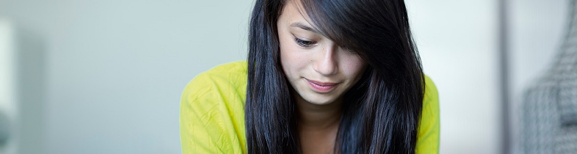 Banner image of woman looking down at tablet