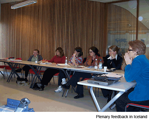 A group of people sitting at tables in a large hall