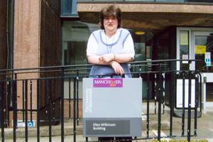 Louise leaning against some railings outside a building