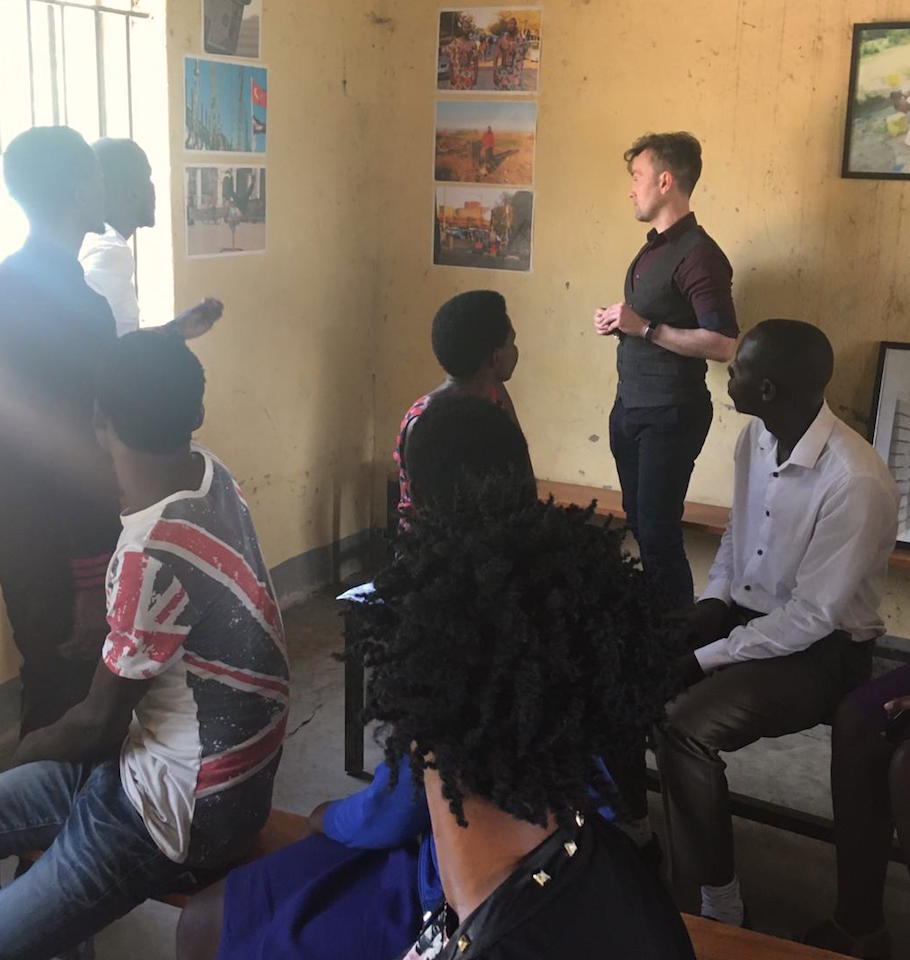 Photo of group of young people looking at photos on wall