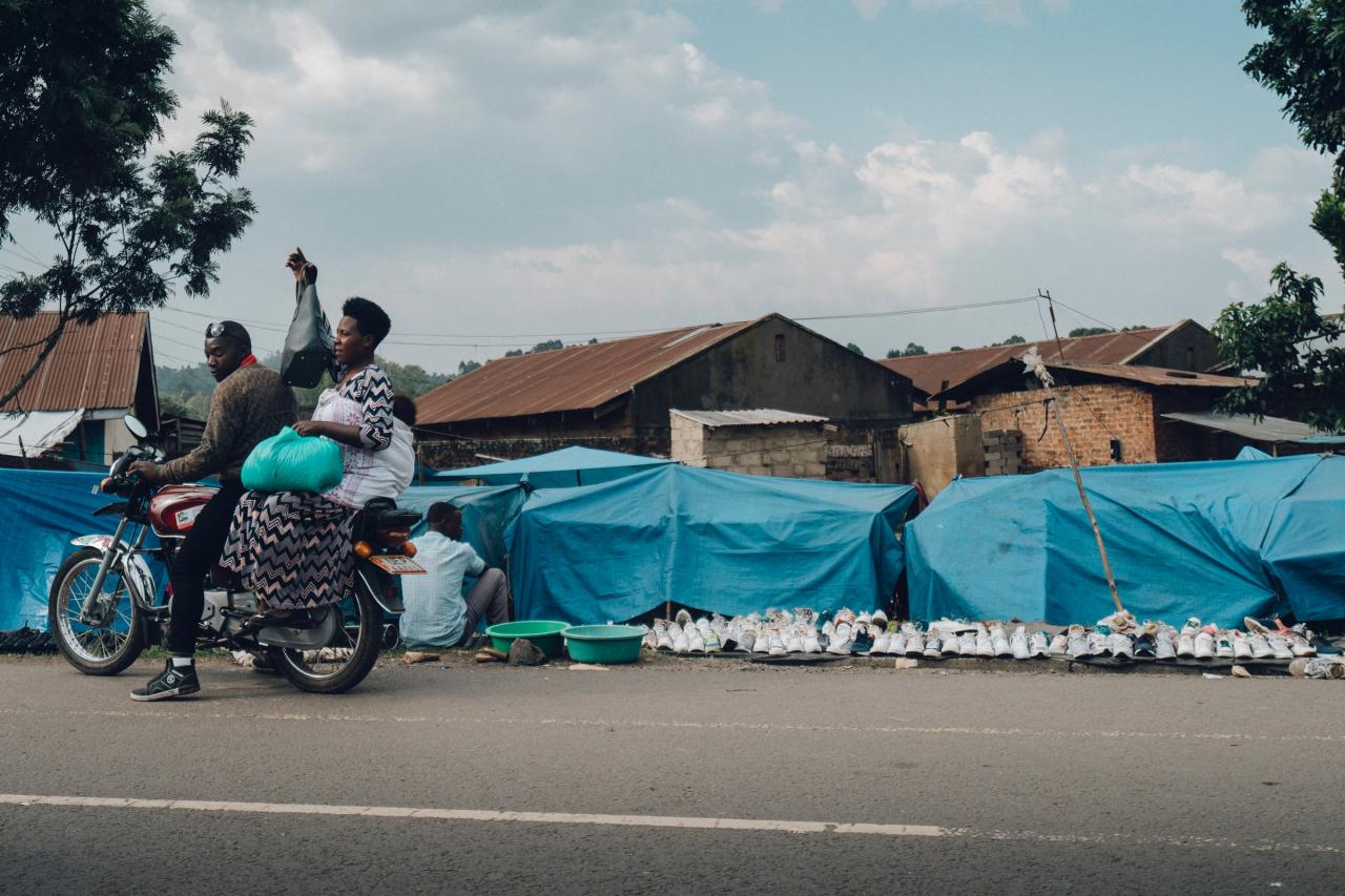 Lady on the back of a motorbike with her baby. Photo by Random Institute on Unsplash 