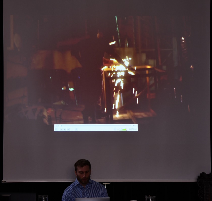 Opening shot of film, “Nollywood + Industry” showing set welders