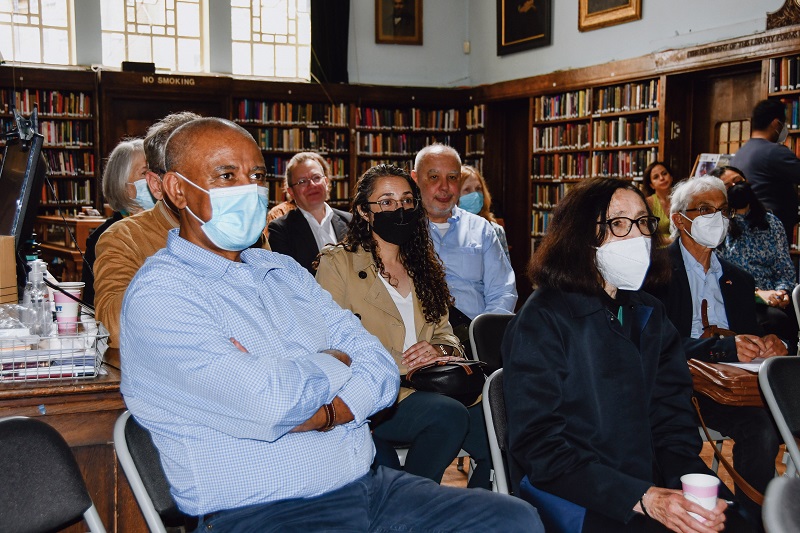 Audience members in Conway Hall Library watching Naushad Forbes plenary