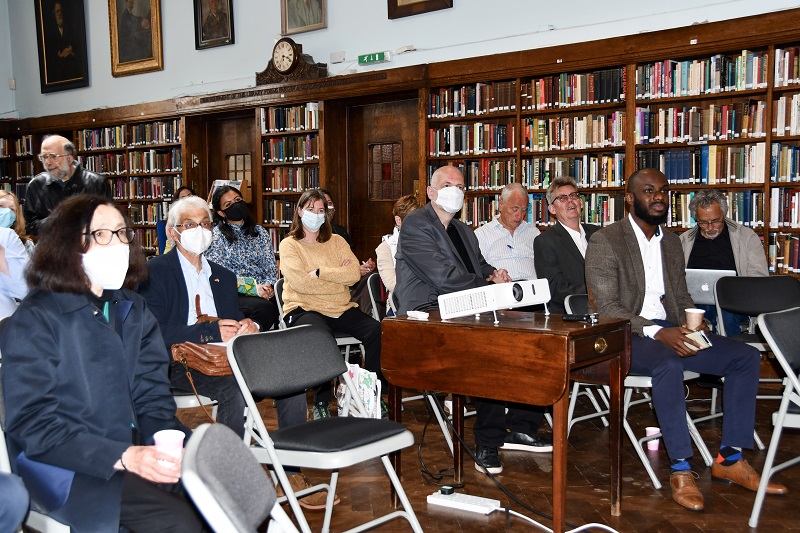 Audience members in Conway Hall Library watching Naushad Forbes plenary