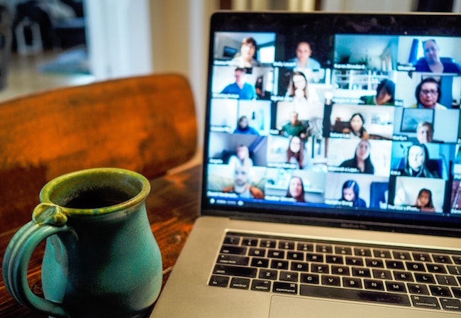 Photo of laptop screen displaying online meeting attendees