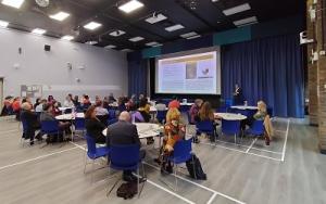 A full room of guests at The Open University in Milton Keynes listen to Professor Giles Mohan