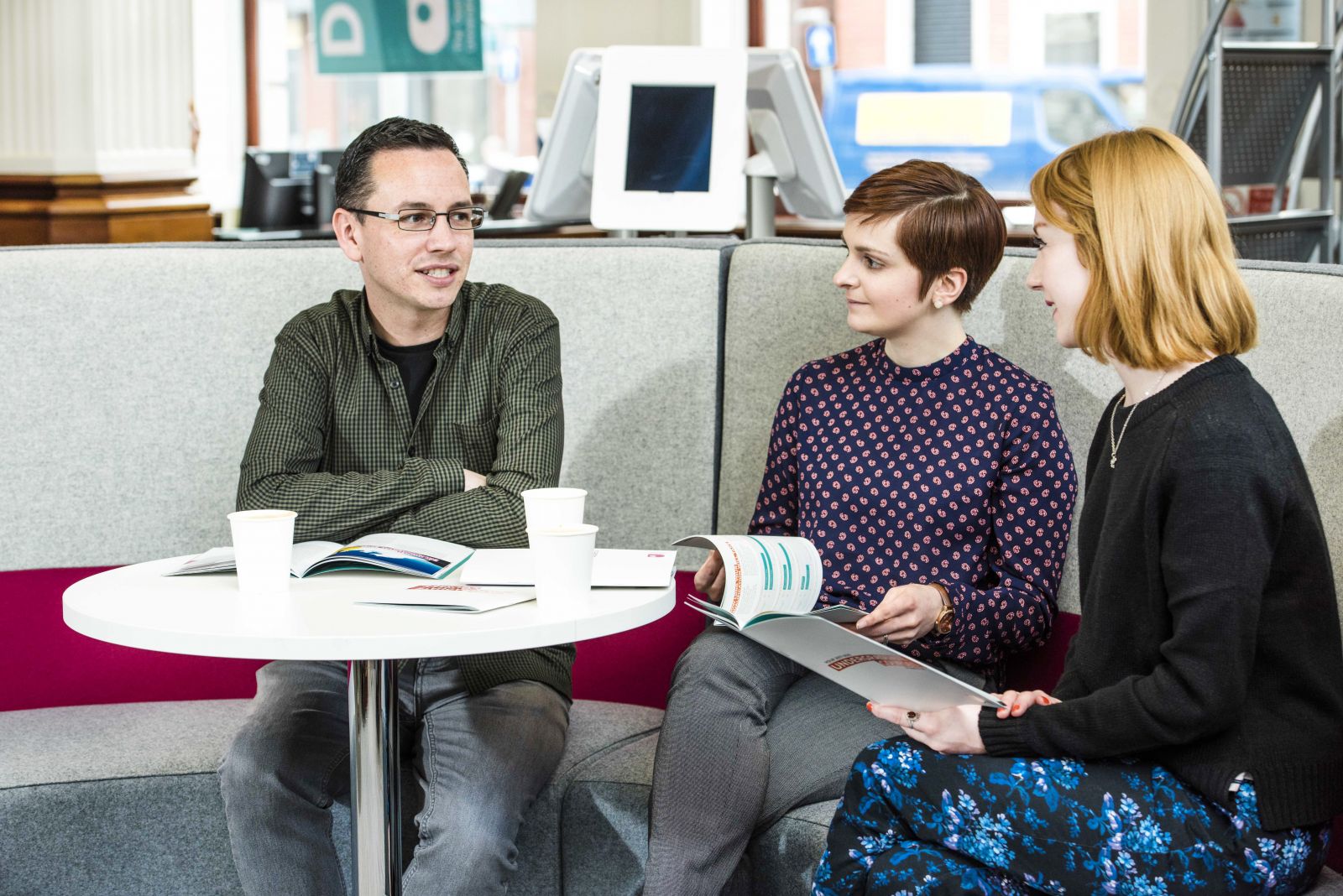 3 people sitting on a sofa in The Open University office reception