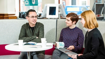 3 people sitting on a sofa in The Open University office reception