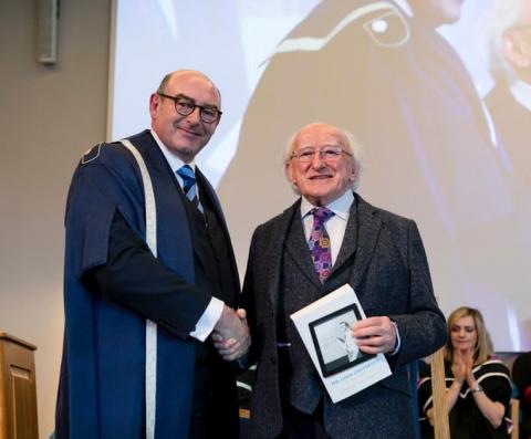 National Director of The Open University in Ireland, John D'Arcy, shaking hands at an OU degree ceremony with the President of Ireland Michael D Higgins