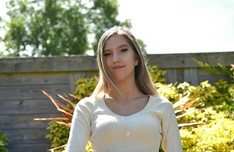 a young woman smiles into the camera