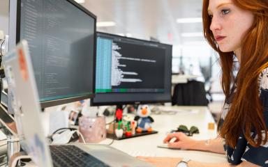 Female student looking at and downloading information