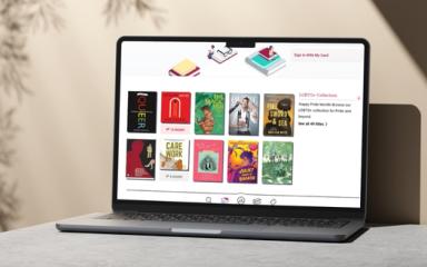An open laptop placed on a desk displays the LGBTQ+ collection on Libby
