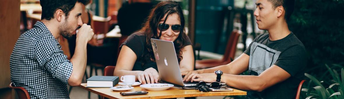 A group of students studying together outside a cafe