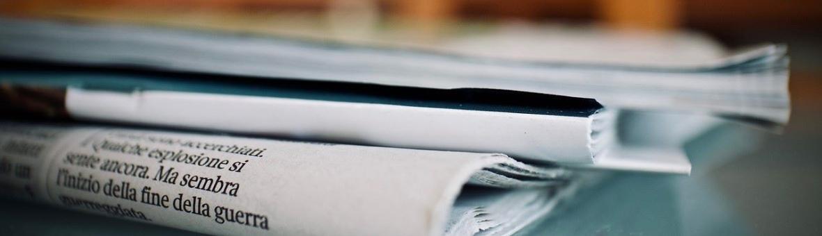 Image of newspapers and journals lying on a table