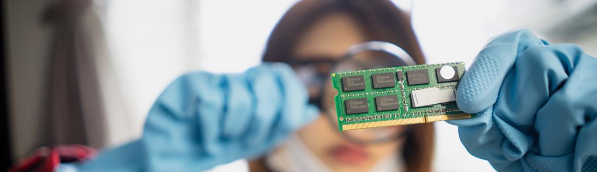 Woman examining and electrical part of a device