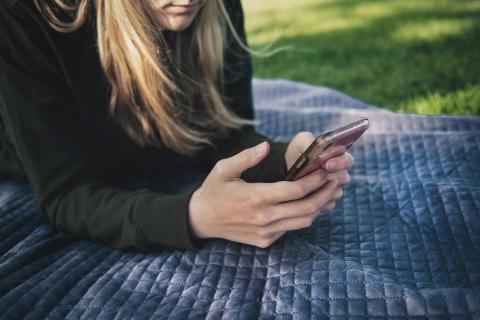 Student using mobile phone to keep up to date