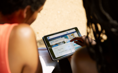 two females looking at an ipad