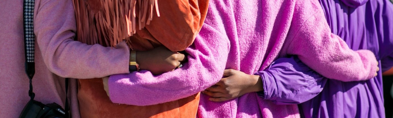 a group of people are pictured hugging from behind