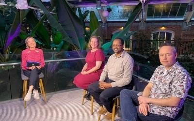 a panel of four people ready to take part in a discussion