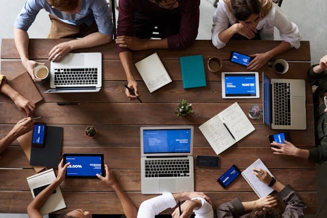 a group of people working together around a table