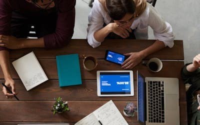 a group of people working around a desk