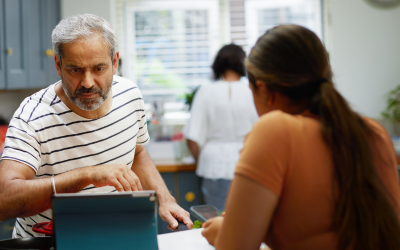 image of two people chatting across a desk