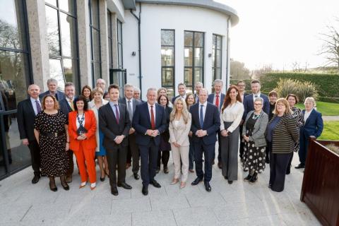 A large group of people standing posing for a photo