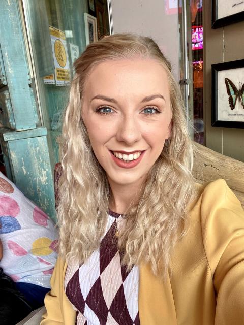  aa young women with blonde hair smiles into the camera