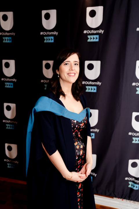 Karen smiling to camera in OU degree ceremony robes