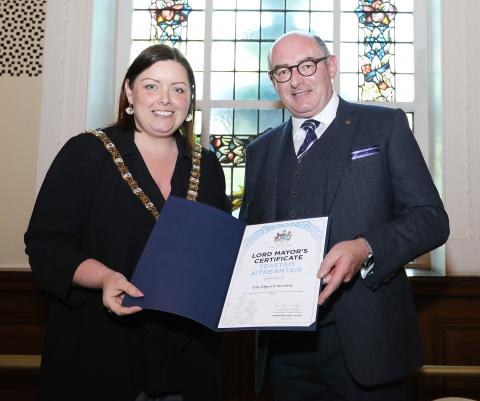 The Lord Mayor and John D'Arcy stand posing for a photo holding a certificate