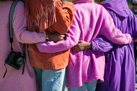 A group of people hugging from behind