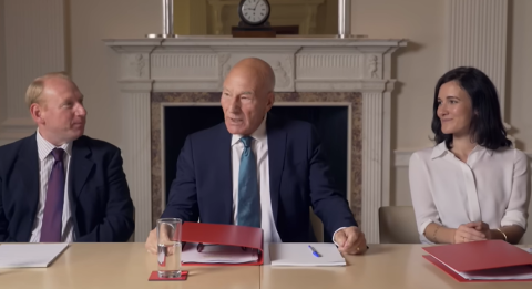 Actor Patrick Stewart with two actors on either side of him