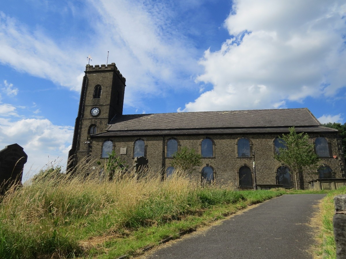 The image shows a church built of stone, with a path leading toward it.
