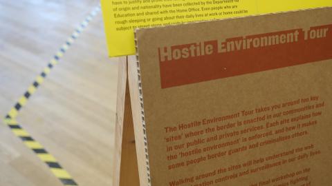 A sign that says 'Hostile Environment Tour'.
