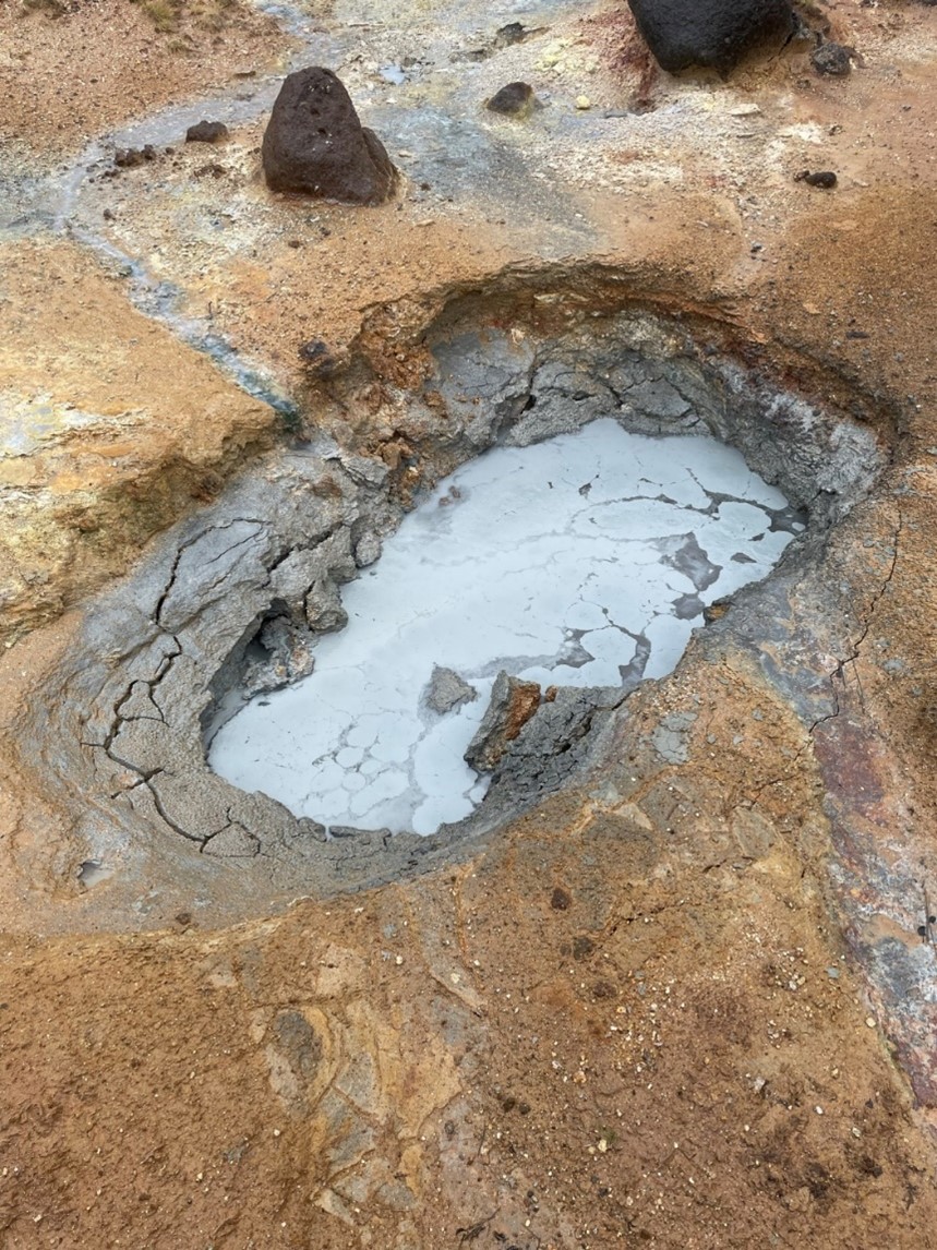 A bubbling pool of clay like liquid.