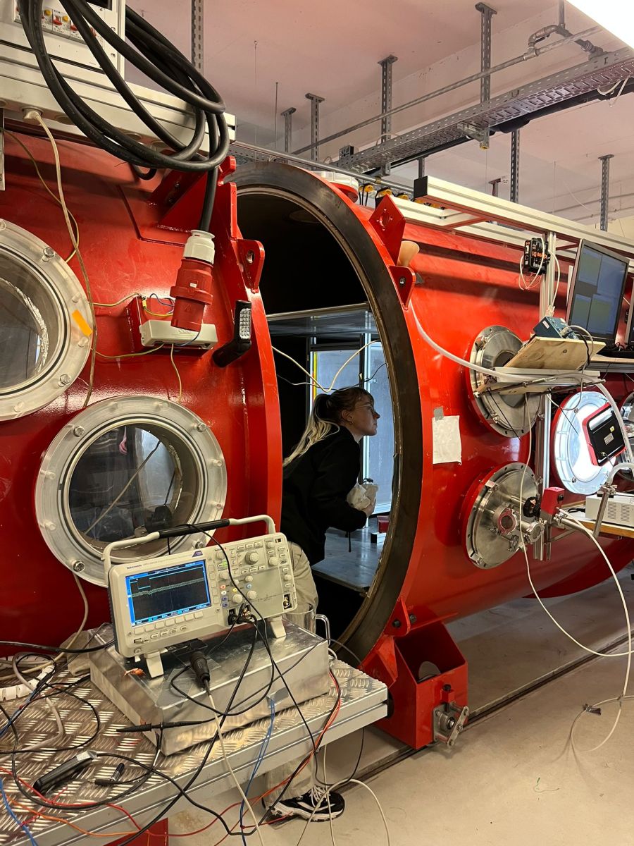 Jessie inside a large piece of red machinery, 