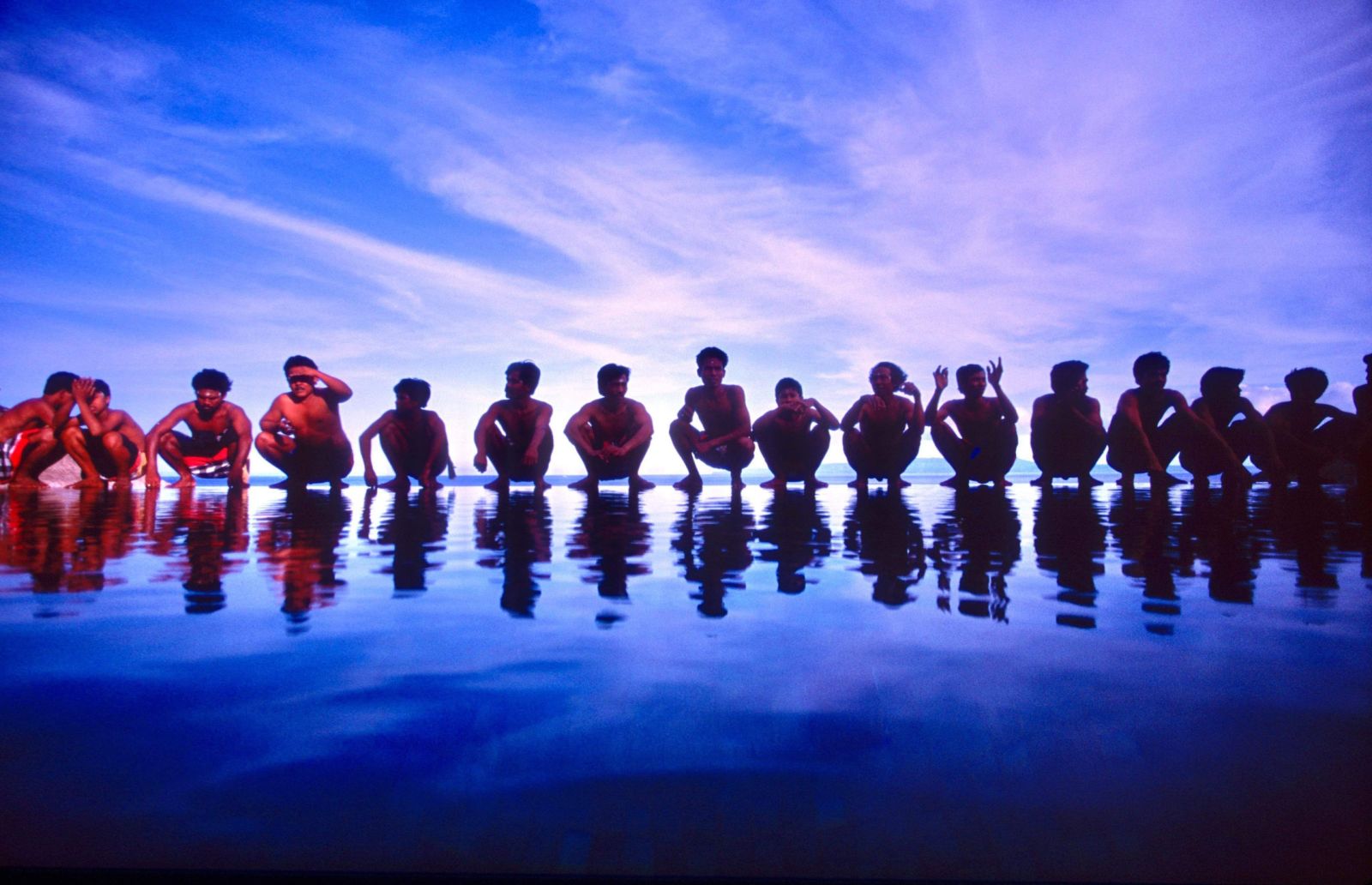 a group of man lined up on beach