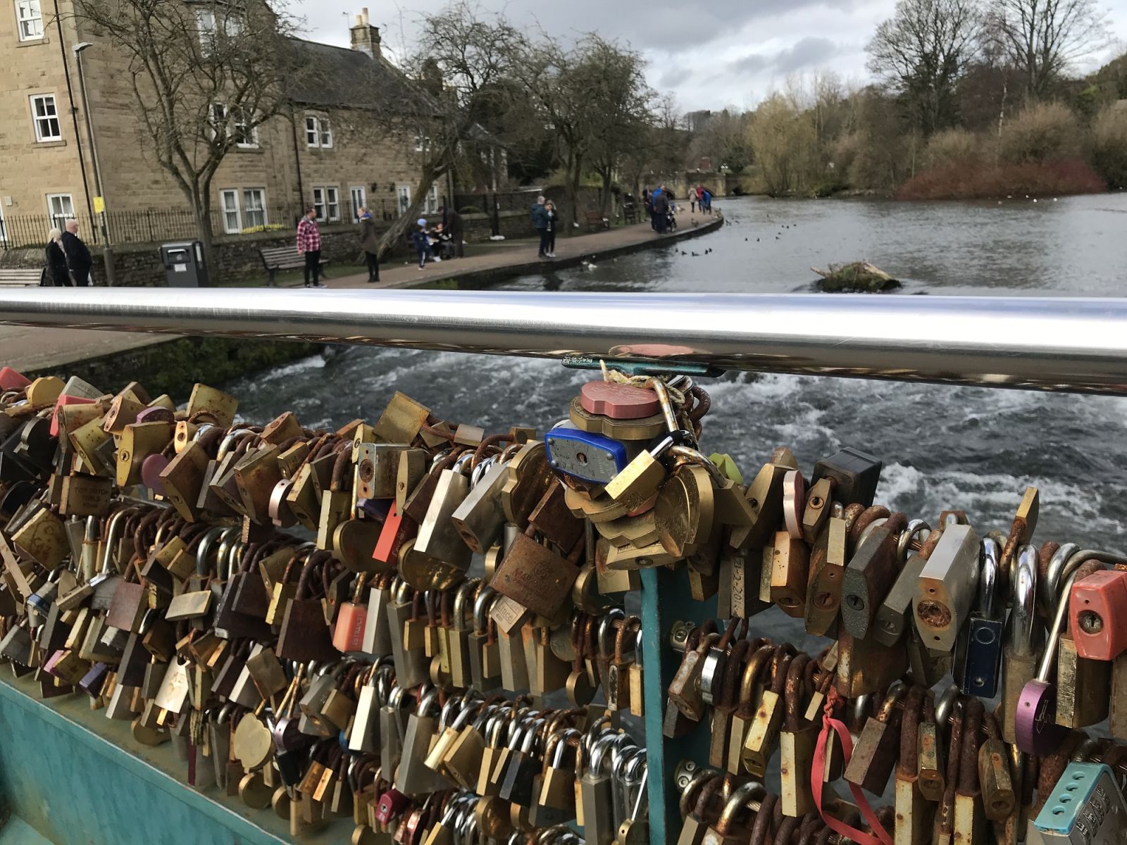 Colourful padlocks span a bridge