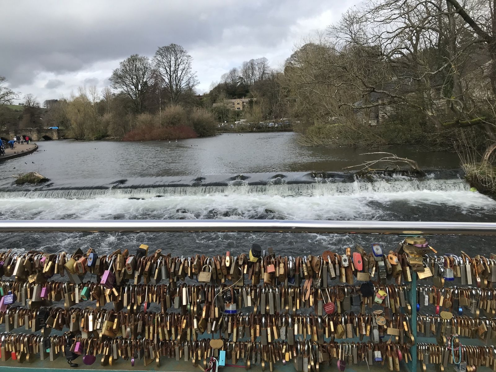 Colourful padlocks span a bridge