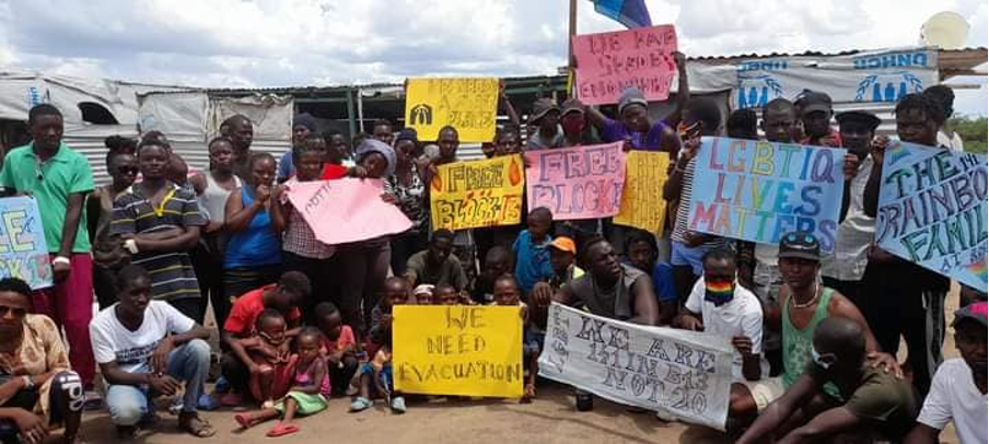 Camp residents holding posters group photo