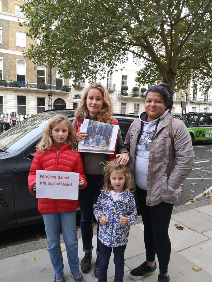 Humanity Knows No Borders Or Nationality: four people hold suppporting letters