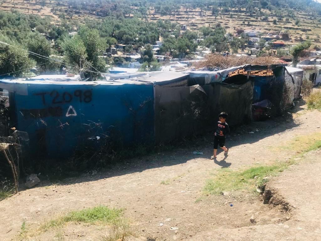 A boy walking in the camp