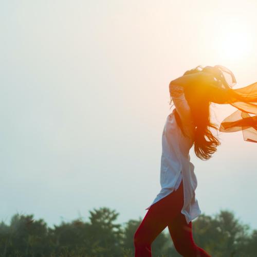 women throwing scarf in the sunset